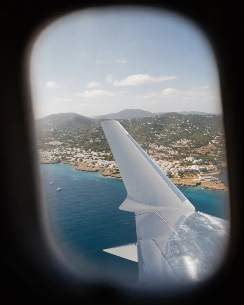 Coastal landscape viewed through a private jet cabin window
