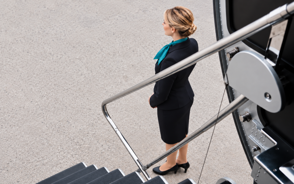 AriyaX flight attendant waiting beside Legacy 650 aircraft stairs